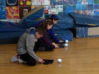 Lane School students programming Sphero robots to move through an obstacle course.