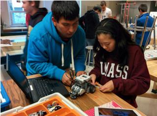 High School students designing and programming a robot.