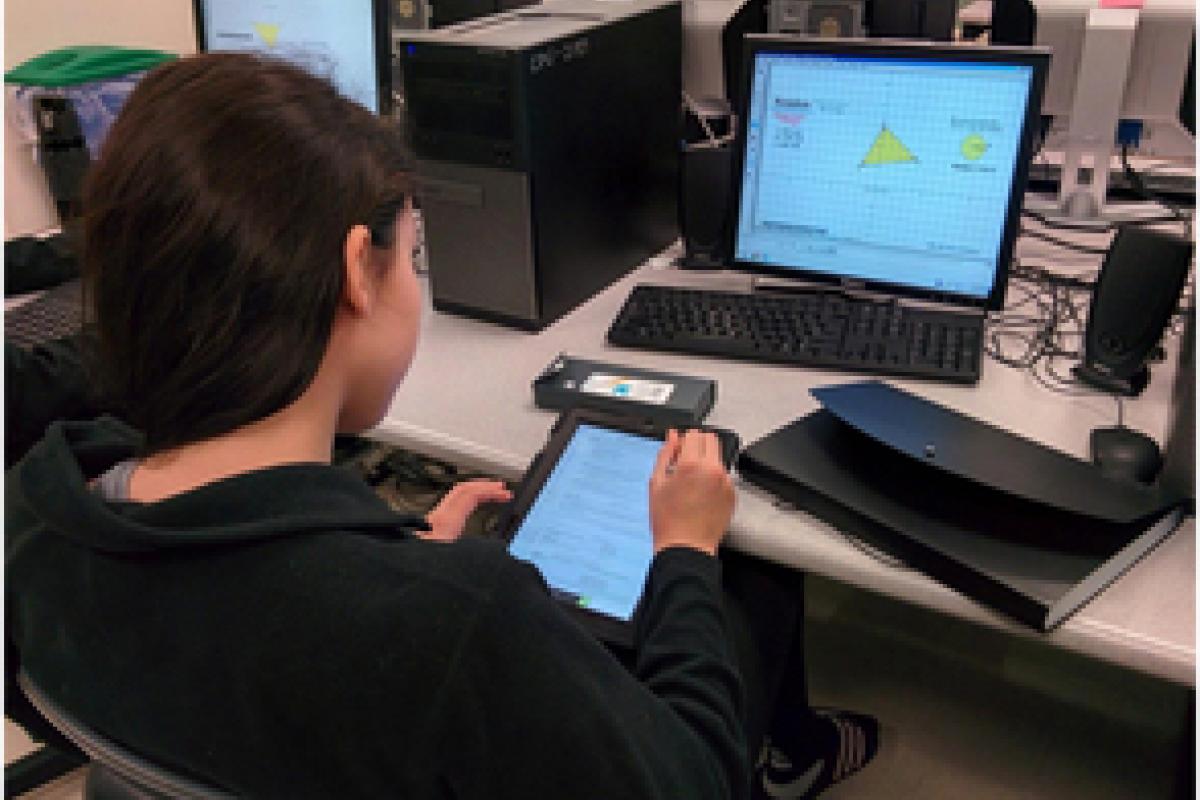 High School student using technology to solve a math problem.
