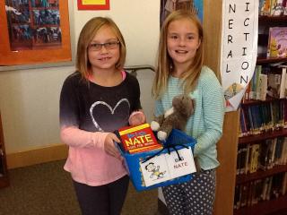 Lane students gathering books for a genre study during library.